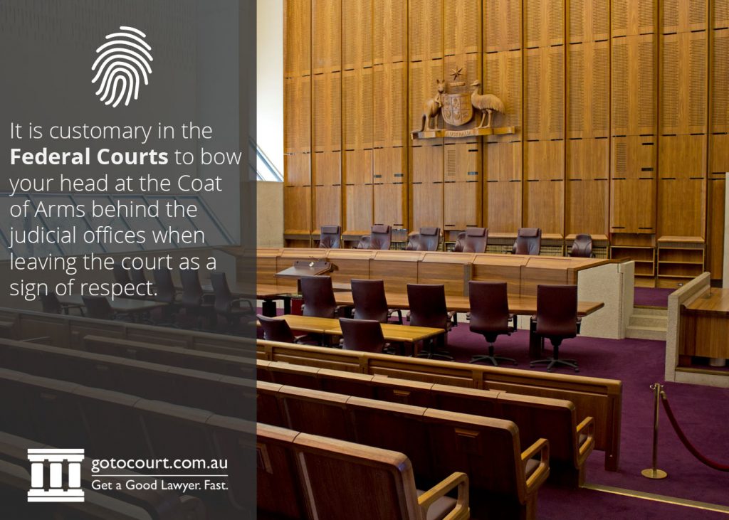 It is customary in the Federal Courts to bow your head at the Coat of Arms behind the judicial offices when leaving the court as a sign of respect.